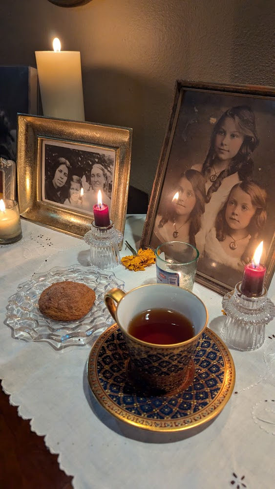 an offering of tea and cookies to an ancestor altar