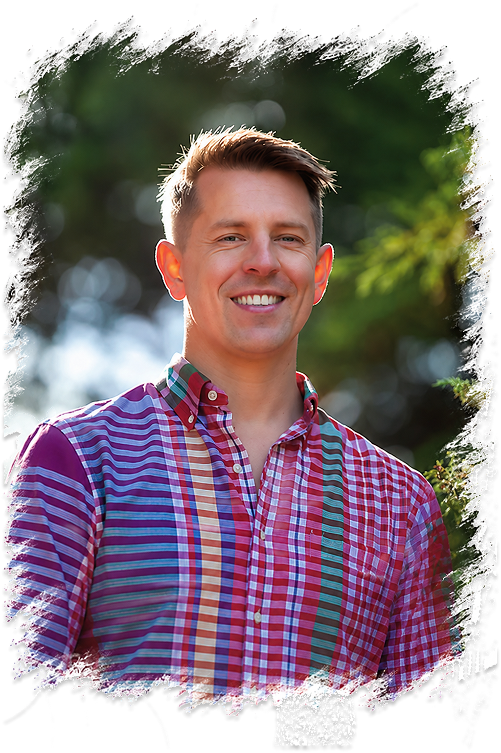 Smiling man in a colorful plaid shirt