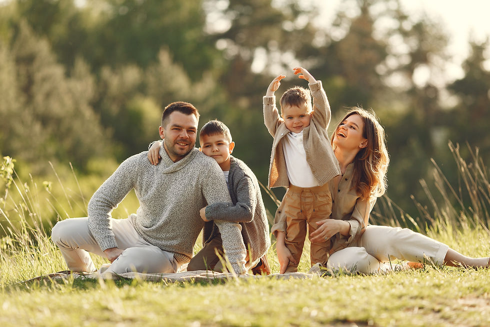 Happy family of four with two children outdoors