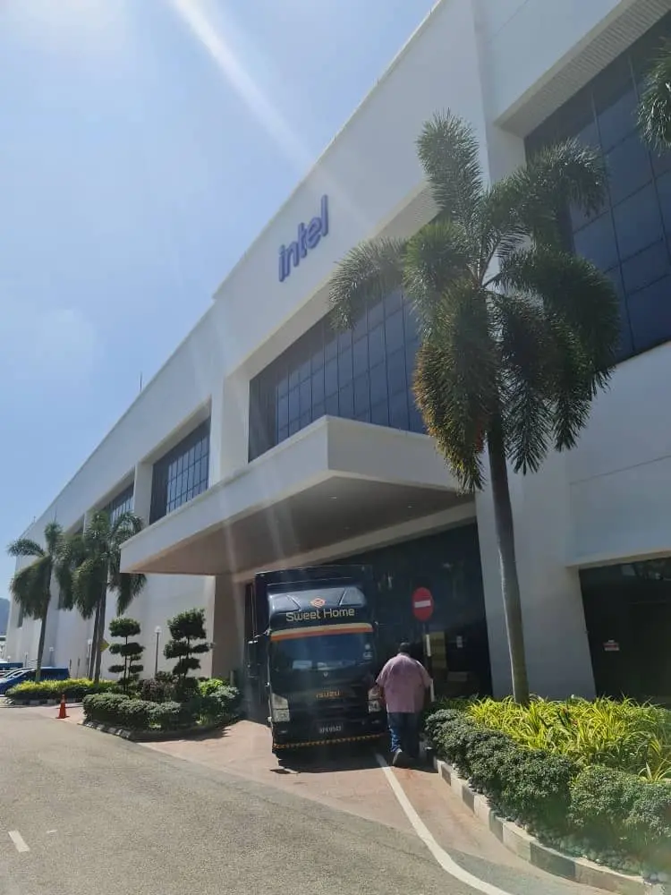 T&J Solutions delivery lorry reversed and parked in front of Intel Malaysia, ready for furniture unloading
