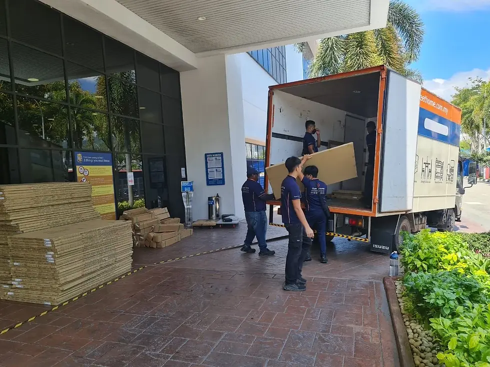 Workers unloading and sorting furniture stock from T&J delivery lorry at Intel Malaysia for on-site installation
