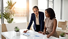 Gen4 professional woman reviewing financial statements with a client The client is a bl