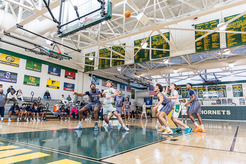 Players from Emmaus and Pottstown watch the ball from under the basket after a free-throw attempt. 