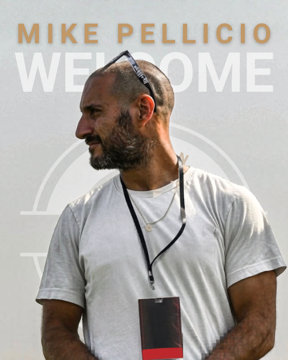 Eye-level view of a soccer coach giving instructions on the field during practice