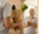 Senior citizen receiving online delivery at home
