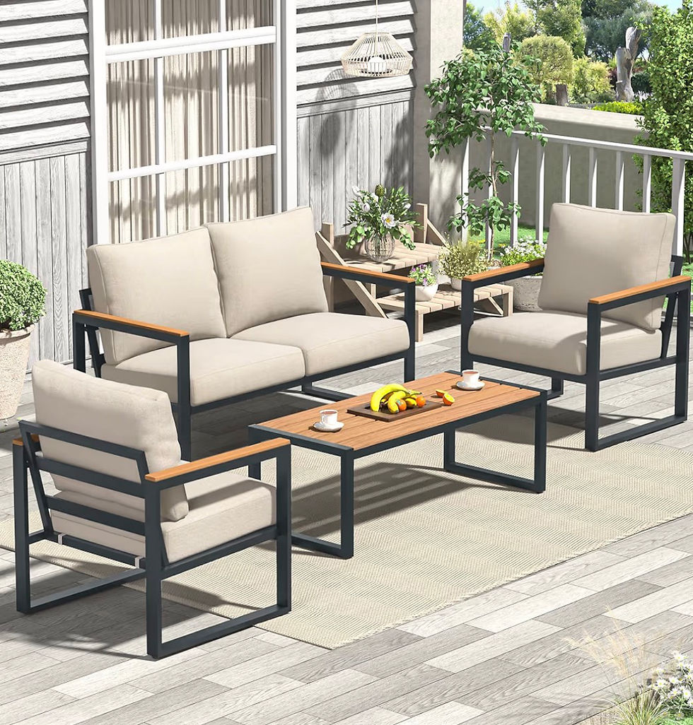 Sunlit patio with beige cushioned sofa and chairs around a wood coffee table with fruit and cups, framed by potted plants.
