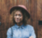 A fun woman smiles as she attends a meeting at The Wellbeing & Recovery Collective.