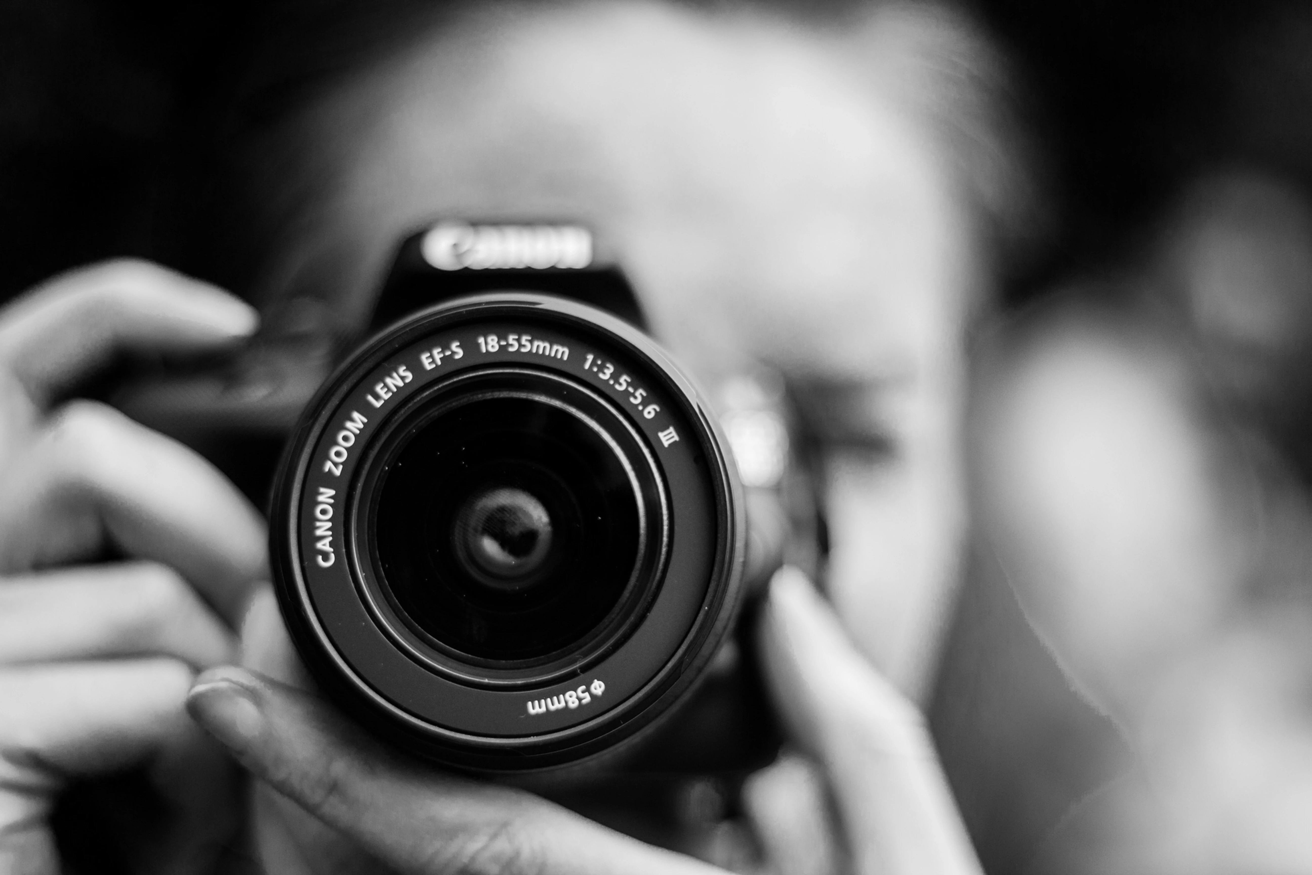A photographer taking a photo of a small business owner to be used for a website designed by DA Creative