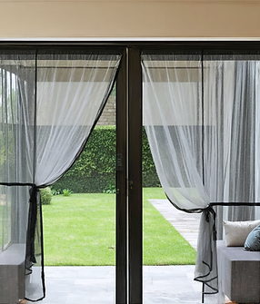 Realistic_image_of_a_magnetic_mosquito_net_installed_on_both_a_door_and_a_wind_20250331041