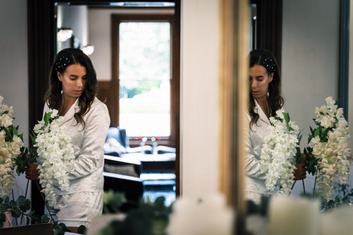 Artistic phot of the bride checking the reception room