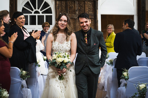 Newlyweds walking out of the room at Place House.
