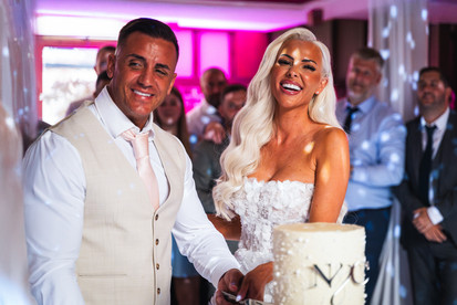 Bride and groom cutting cake shot