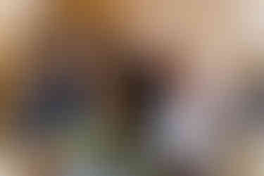 A white shot showing inside of Normanton Church, bride and groom kiss after lighting the candles.