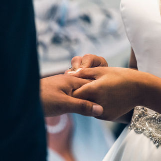 Put a ring on it! Bridesmaid putting a ring on husbands finger