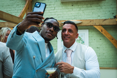 Groom taking a selfie with his mate