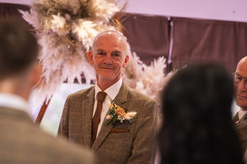 Groom seeing bride walking down the aisle.