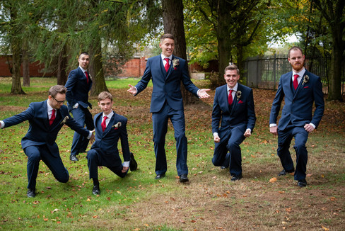 Funny photo of the groomsmen goofing around during afternoon photo session.