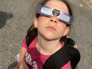 Girl enjoying the solar eclipse with special glasses