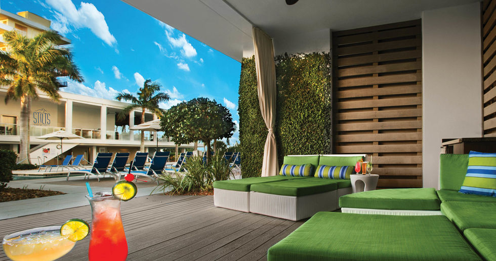 Luxury resort patio with cocktails, pool view & cabana.  Marriott's Crystal Shores, Marco Island beach