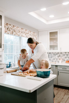 mom and kids baking an apple pie