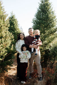 family portrait at christmas tree farm