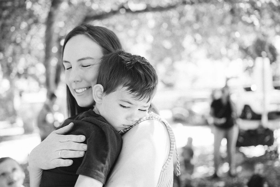 black and white photo of mom hugging son