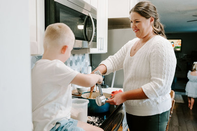 mom and two kids backing an apple pie