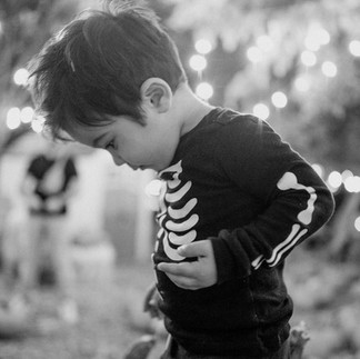 black and white photo of boy wearing skeleton costume at Moreland pumpkin patch
