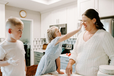 mom and two kids backing an apple pie