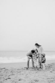 black and white of family of four, mom dad, toddler boy and daughter