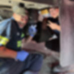 Two LTL Mechanics working on trailer.