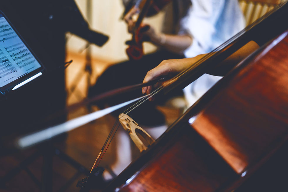 Up close action shot of a string quartet performing Bridgerton-style pop music at a luxurious wedding. 