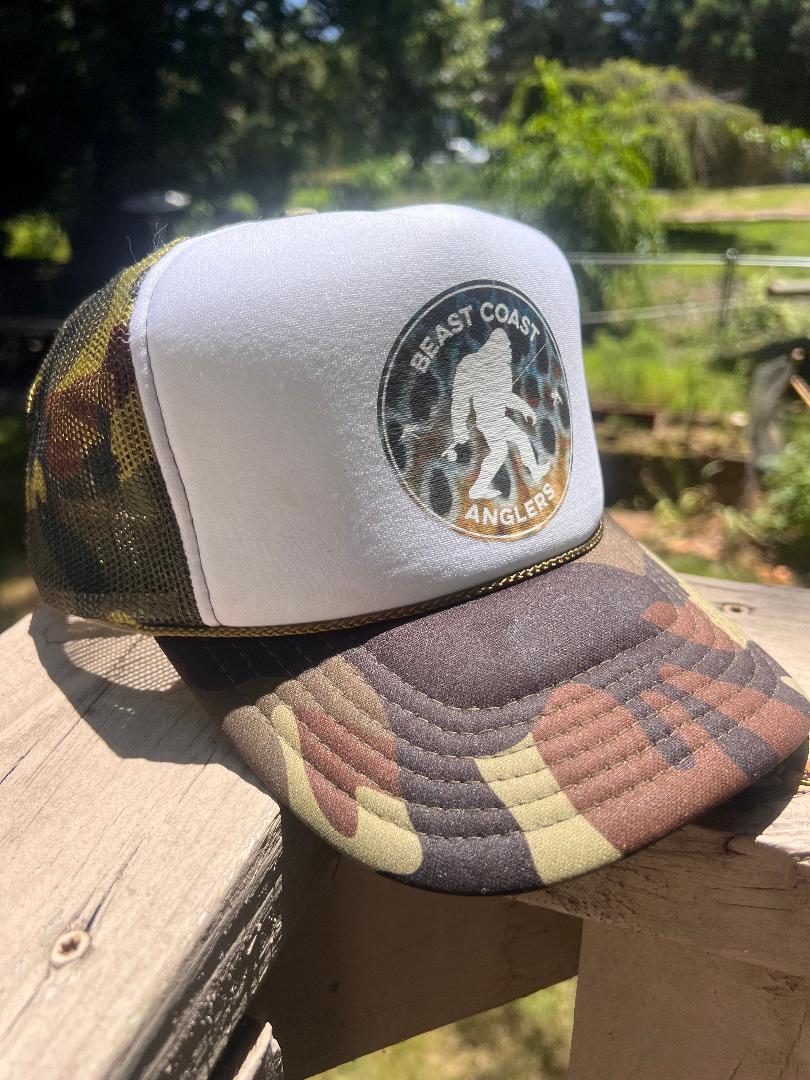 A stylish new branded Beast Coast Anglers cap sitting on a wooden dock.