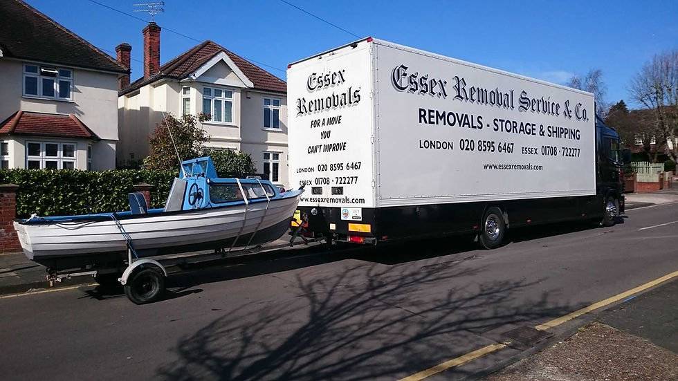 Removal lorry with a boat in tow