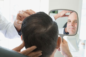 surgeon consulting male patient with mirror