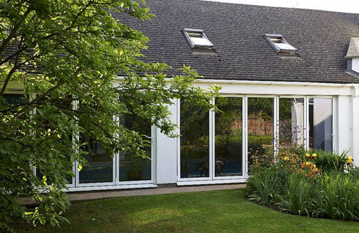 Row of white patio doors on a long property