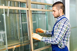 Worker measuring glass at a modern factory