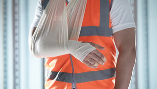 Close up of worker with arm in a sling