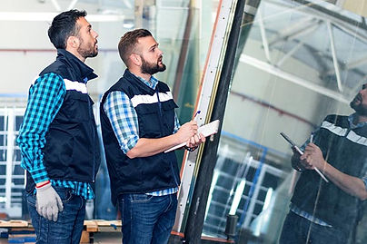 Two glaziers inspecting glass