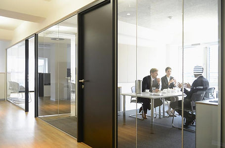 business meeting in glass walled office