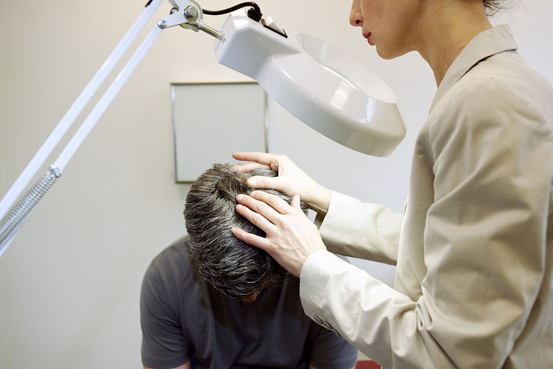 Consultant checking a patient's scalp