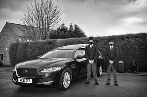 Funeral Car with staff stood beside it