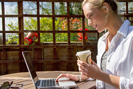 Young woman with laptop in garden