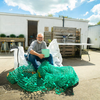 Ecotribo Founder with a batch of ghost nets found on a local beach and made into the latest range of ocean plastic plant pots.