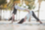 People doing yoga at the beach