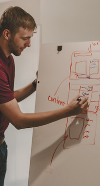 man drawing on dry-erase board_edited.jp