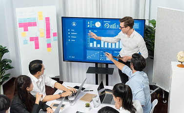 Presentation in office or meeting room with analyst team utilizing BI Fintech to analyze f
