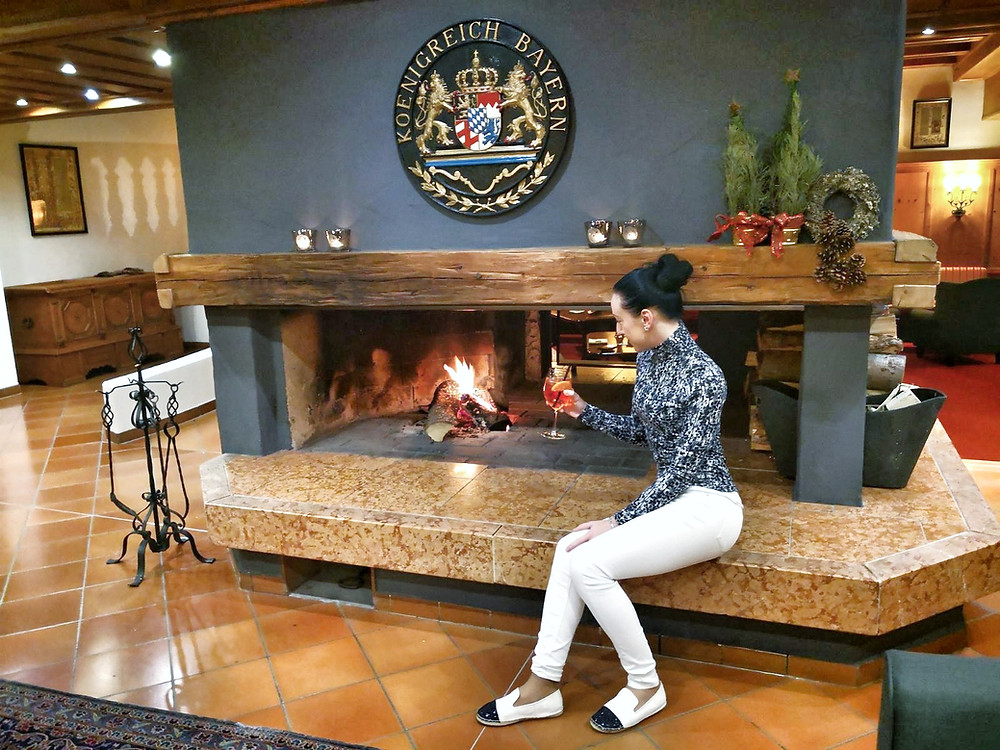 Claire by a fireplace in Riessersee hotel