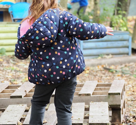 Girl in coat in the Foxyards outdoor area.