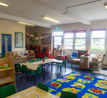Little Acorns classroom with child furniture and play rug